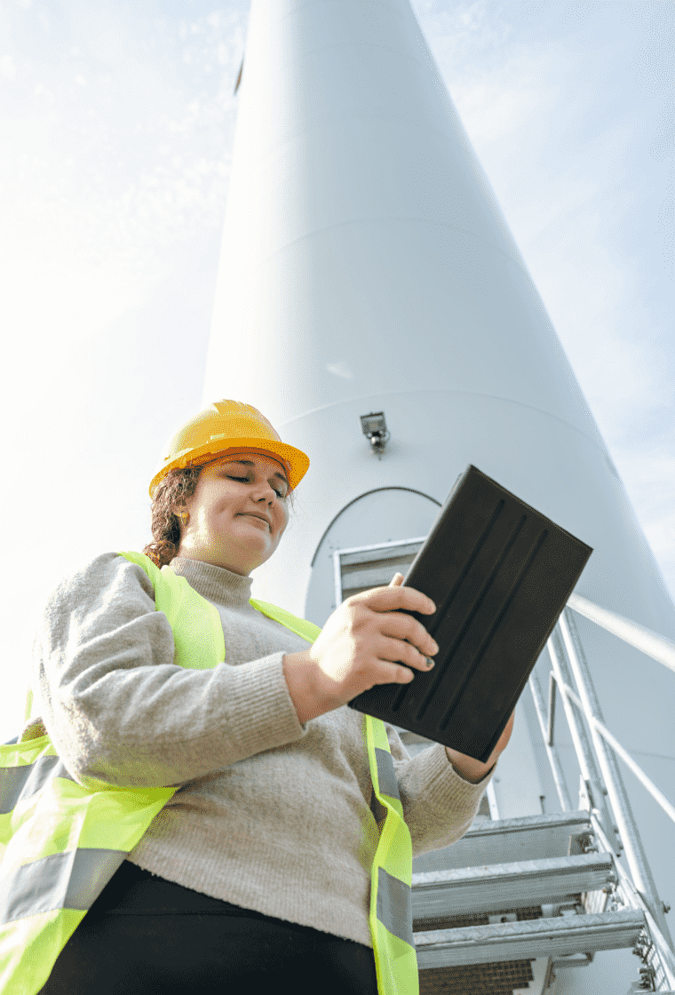 Energy sector worker smiling with a tablet